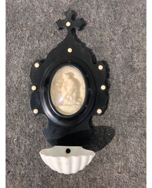 Holy water stoup in ebonized wood and porcelain bowl with sea foam oval with saint figure. France.     