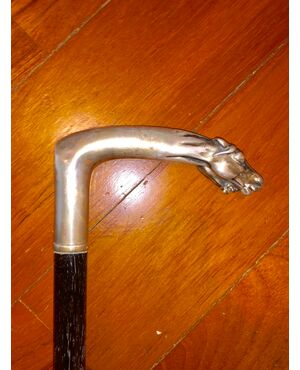 Stick with silver handle depicting two horse heads. Ebony tip     