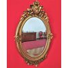 Golden oval mirror