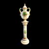 Grande vaso con colonna in maiolica decorato con motivi geometrici e vegetali stilizzati in ‘soprabianco’,con medaglioni e mascheroni.Manifattura di Ferruccio Mengaroni.Pesaro.