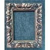 Carved and gilded wooden frame with stylized leaves motif.     