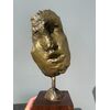 Scultura in bronzo dorato con base lignea.Firmata.