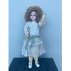 Doll with bisque head and original dress. 1902 initials and numerical elements.     
