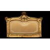 Cornice capoletto in legno intagliato e foglia oro con motivi floreali e rocaille.