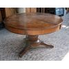 Large round table in walnut with a central leg     