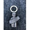 Silver baby rattle depicting an accordion player. Ivory ring.Europe.     