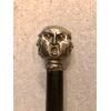 Bastone con pomolo in metallo raffigurante 4 facce grottesche.Canna in ebano.