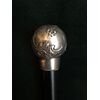 Round silver stick with knob with rocaille and floral motifs.     