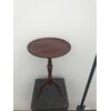 Round table in walnut with central leg and three feet.     