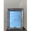 Silvered copper mirror frame with rocaille silver decoration.     