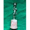 Silver candlestick with rose quartz base depicting a naked boy holding the candle holder Italy.     