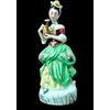 Polychrome porcelain veilleuse-teapoy depicting a lady with watering can. France