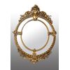Antique French Napoleon III medallion mirror in gilded and carved wood. 19th century period.