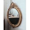 Large oval gilded wooden mirror with a cyma with a curl