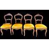 Four walnut chairs carved with rocaille motifs.