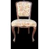 Four walnut chairs with floral pattern carvings.