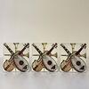FORNASETTI, group of three white metal bookends decorated with musical instruments     