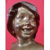 Face of a smiling girl in signed Bronze