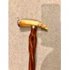 Bastone con pomolo in avorio di facocero con testa di cane e canna intrecciata.
