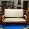 Sofa in Pompeian red and gilded lacquered wood     