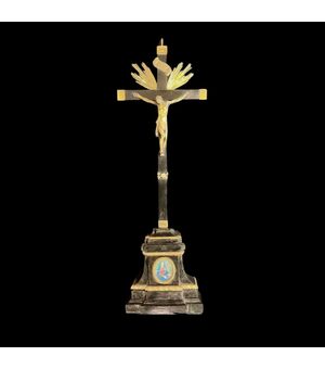 Cristo in bronzo con croce e base in ebano e modanature in argento.Sulla base miniatura  raffigurante ‘Madonna dei sette dolori’.Italia.