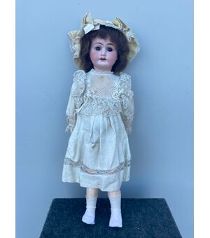 Doll with bisque head and papier-mache body. Original clothes. 1902 signature and letter I.     