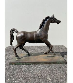 Bronze sculpture with base depicting a horse.     