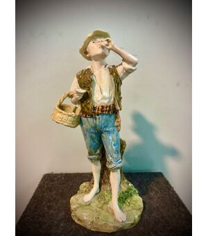 Polychrome majolica sculpture depicting a farmer drinking eggs. Author&#39;s initials on the base. Ginori Manufacture.     