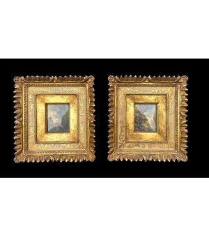 Coppia di dipinti miniatura su tavola raffiguranti paesaggio con figure.Cornice in legno intagliato e dorato.