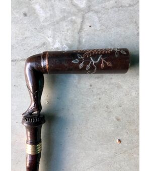 Stick with wooden and metal handle depicting a woman&#39;s leg.     