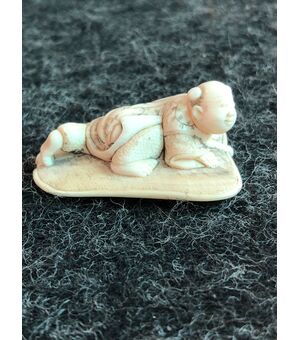 Netsuke in ivory depicting a character on a lotus leaf. Japan     