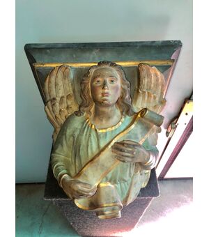 Terracotta shelf depicting Angel with ribbon.Italy     