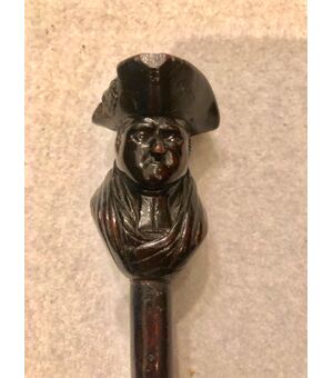 Stick with ebony knob depicting a character with a hat.     