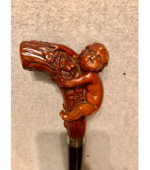 Stick with knob in boxwood depicting a boy climbing.     