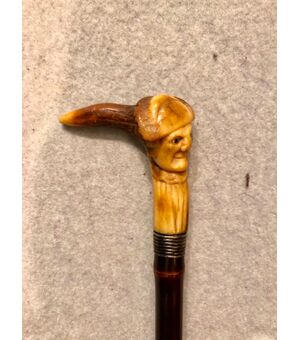 Stick with deer horn knob with grotesque male figure.     