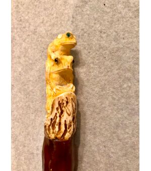 Stick with deer bone knob, depicting frogs.     