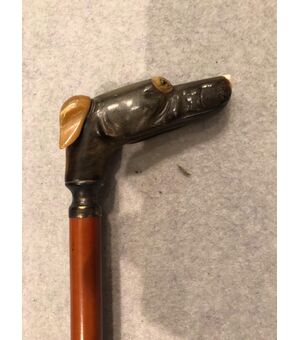 Stick with knob representing a greyhound dog head in horn.     
