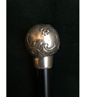 Round silver stick with knob with rocaille and floral motifs.     