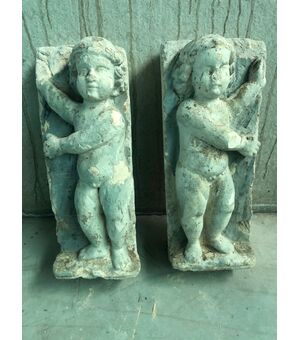 Pair of plaster sculptures depicting children.     