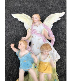 Bisque porcelain stoup with angel figure with outstretched wings protecting two children. France.     