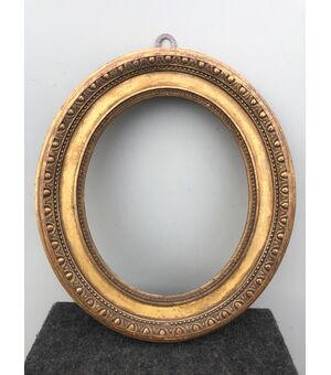 Frame in carved wood and gold leaf with geometric motifs.     
