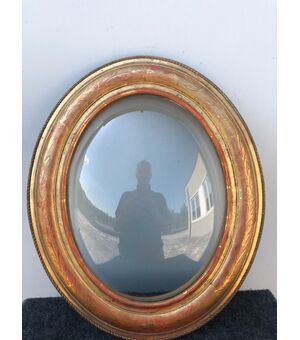 Carved wooden frame with leaf and gold leaf motifs. Domed glass. Louis Philippe period.     