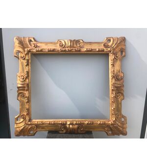 Carved and gilded wooden frame with art nouveau rocaille motifs.     