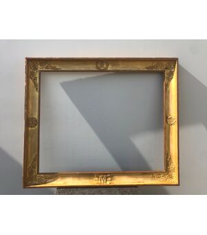 Frame in carved wood and gold leaf with tablet details.     