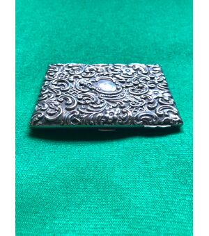 Embossed silver ticket holder with plant and rocaille motifs and inscription with date: Maud 1912. England.     