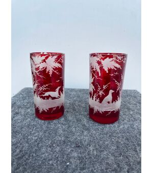 Pair of bohemian glasses in cased glass with grinding wheel decoration depicting hunting scenes.     