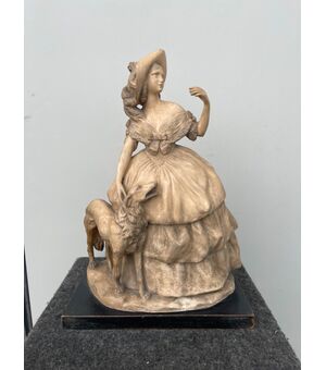 Terracotta sculpture depicting a lady with a dog.Signed (a pupil of Cacciapuoti).     