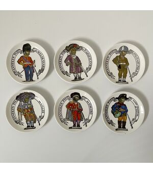 FORNASETTI, six under Manneken Bis saucers, painted ceramic     