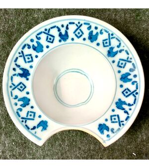 Round plate in blue monochrome majolica with geometric motifs on the brim. France.     