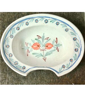 Majolica oval shaving plate decorated with floral motifs. France.     